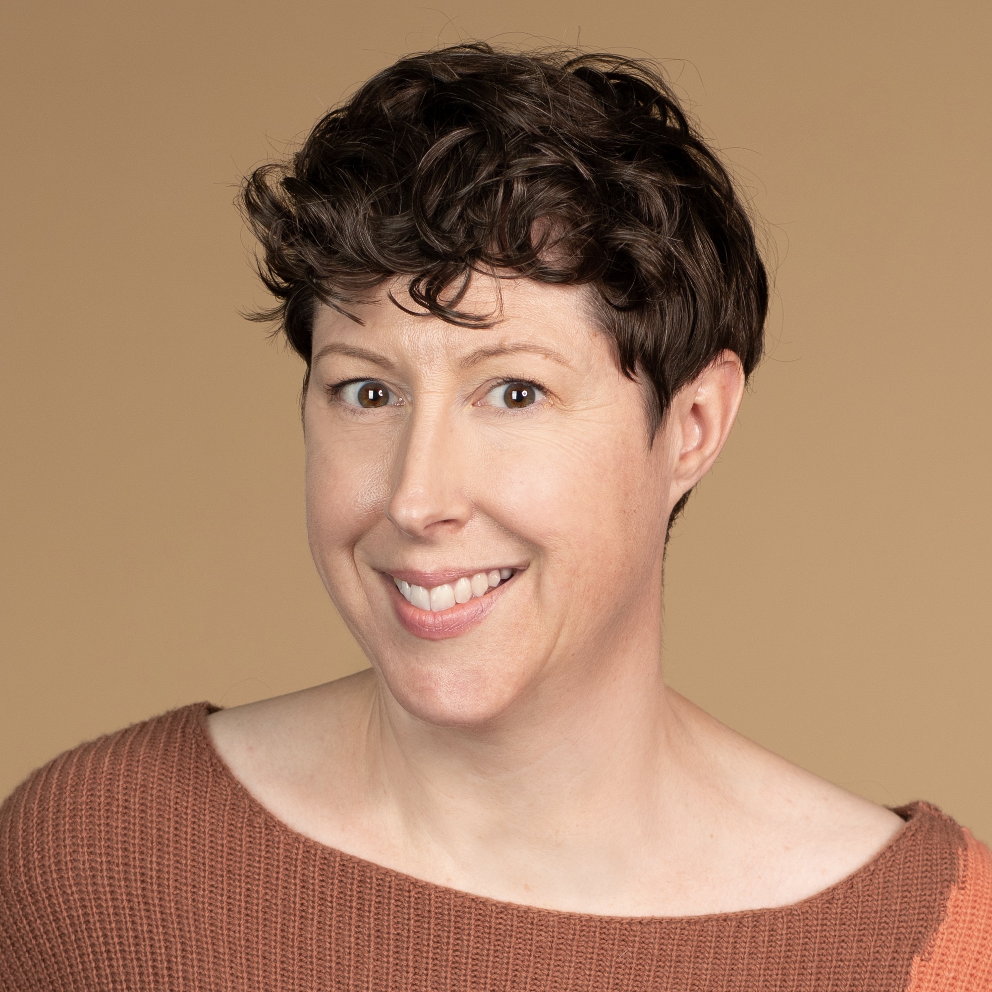 Headshot of Sara Simpson. She is white, has short brown hair, and an engaging smile.